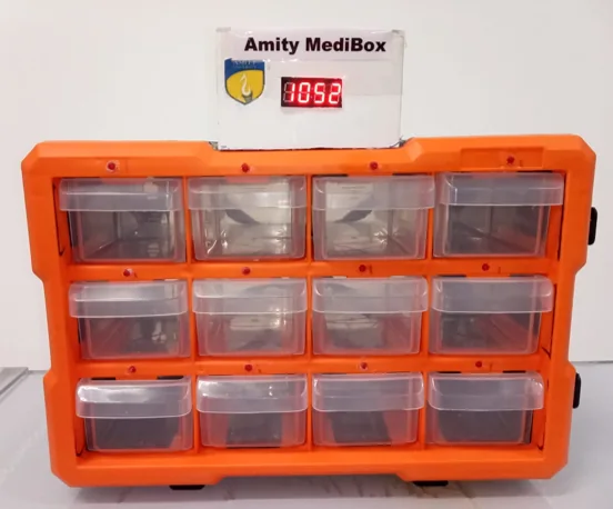 Original Amity MediBox prototype with organised medicine compartments and reminder display